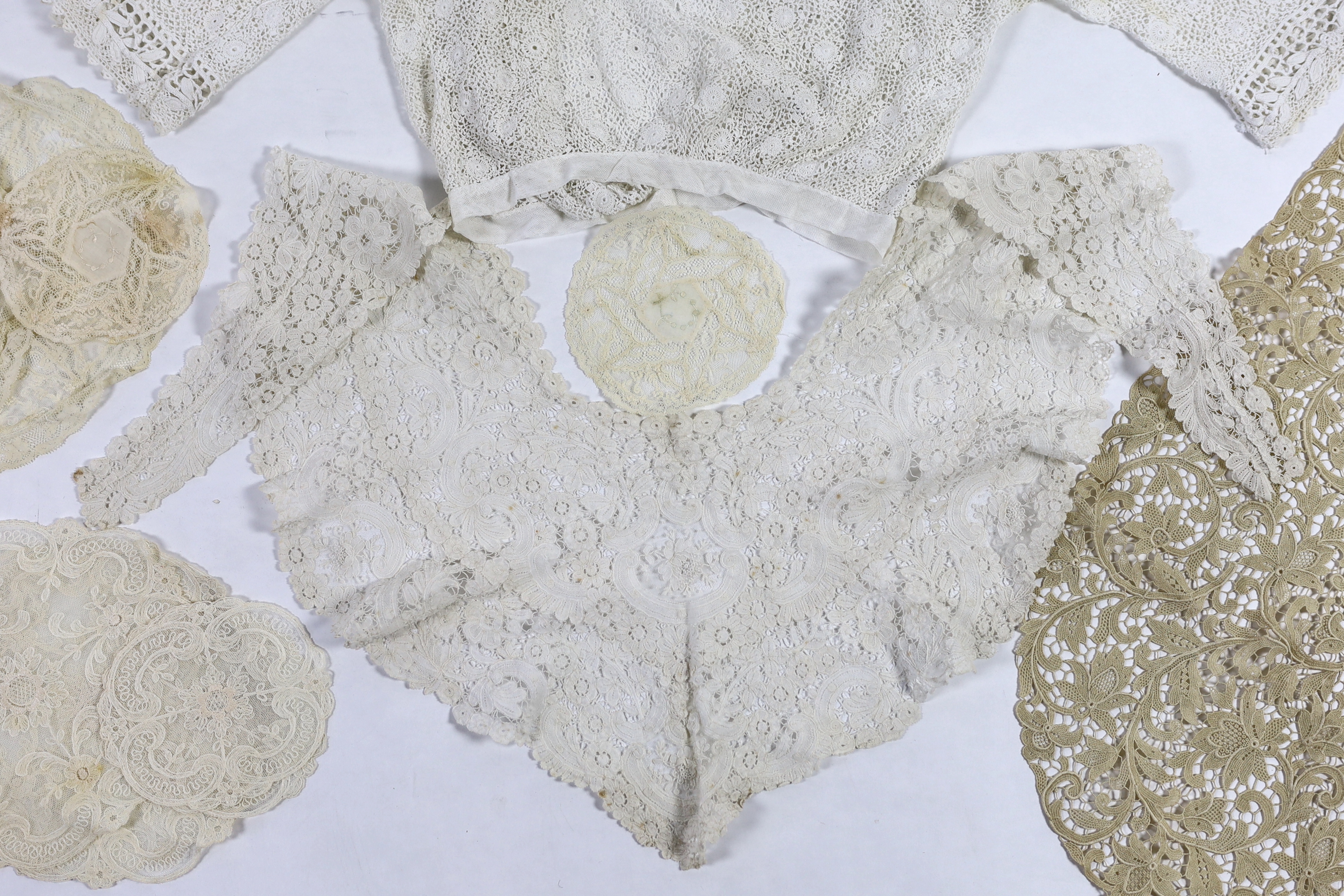 An Edwardian handmade Irish crocheted ladies blouse (small size), a Brussels hand bobbin lace Bertha with Point de Gaze insertions, two large and one small Normandy lace mats, four large and two smaller similar needle la